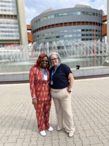 Chris and Sophie, co-founders of CTI, stand outside of the United Nations Office on Drugs and Crime in Vienna